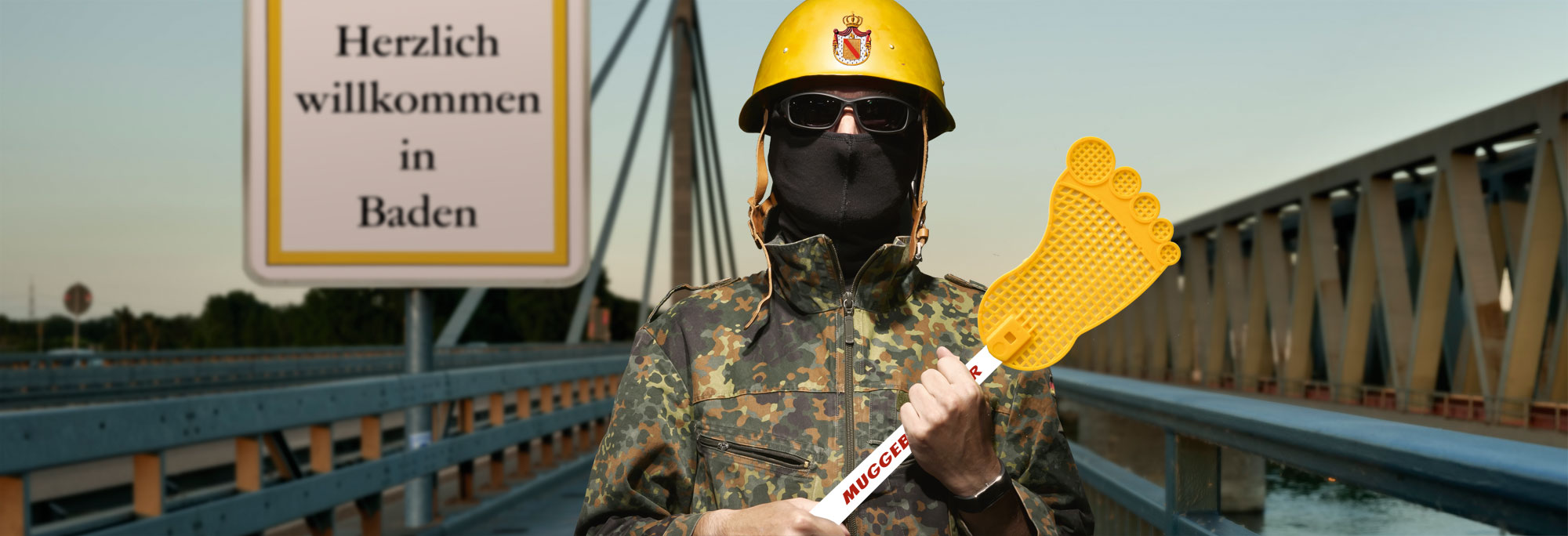 satirische Darstellung eines Uniformierten mit Muggebadscher an der badischen Landesgrenze